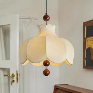 Walnut and white scalloped pendant lamp with wooden beads in three-quarter view against neutral interior background