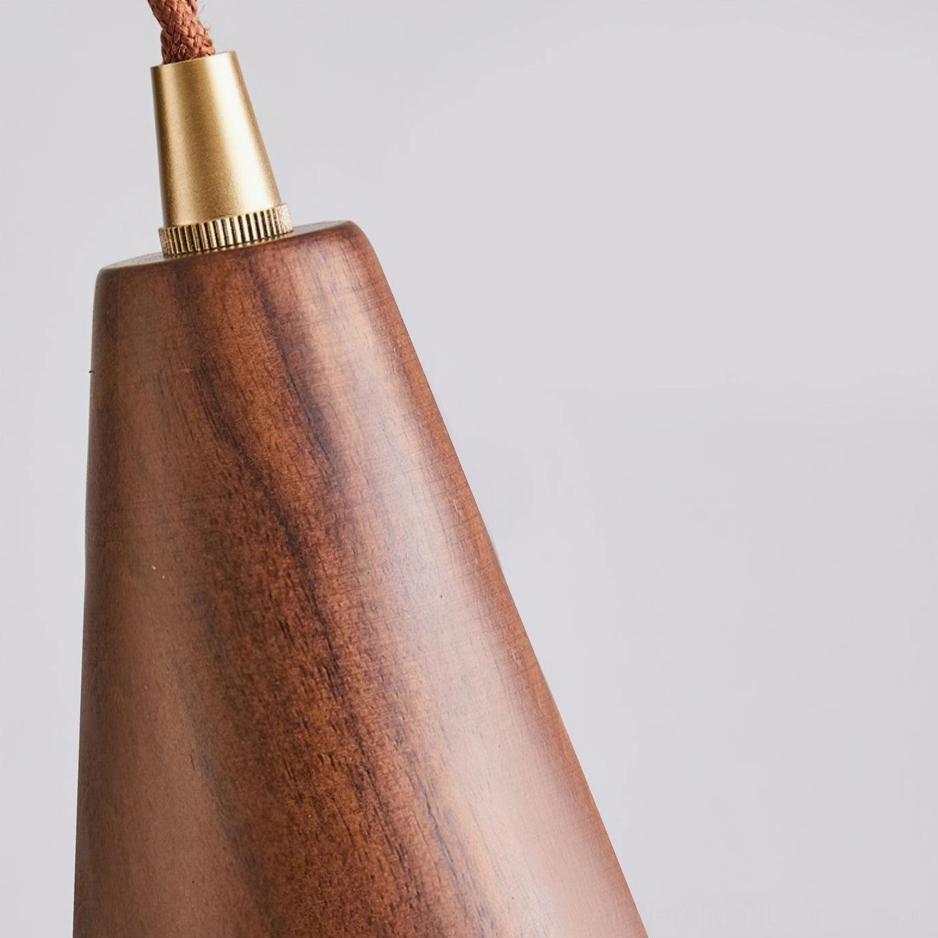 Walnut wood grain glass pendant shade creating soft ambient lighting, natural material pendant for mid-century modern style