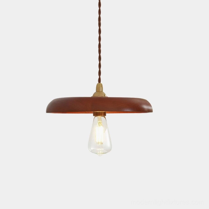 Walnut wood pendant light with brass fittings and twisted fabric cable on white studio background