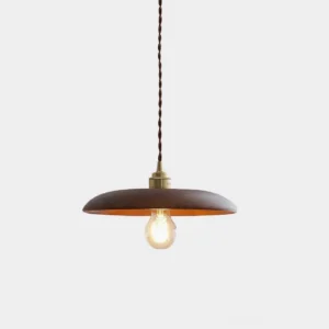 Modern walnut wood disc pendant light with brass hardware and twisted fabric cord, front angled studio view