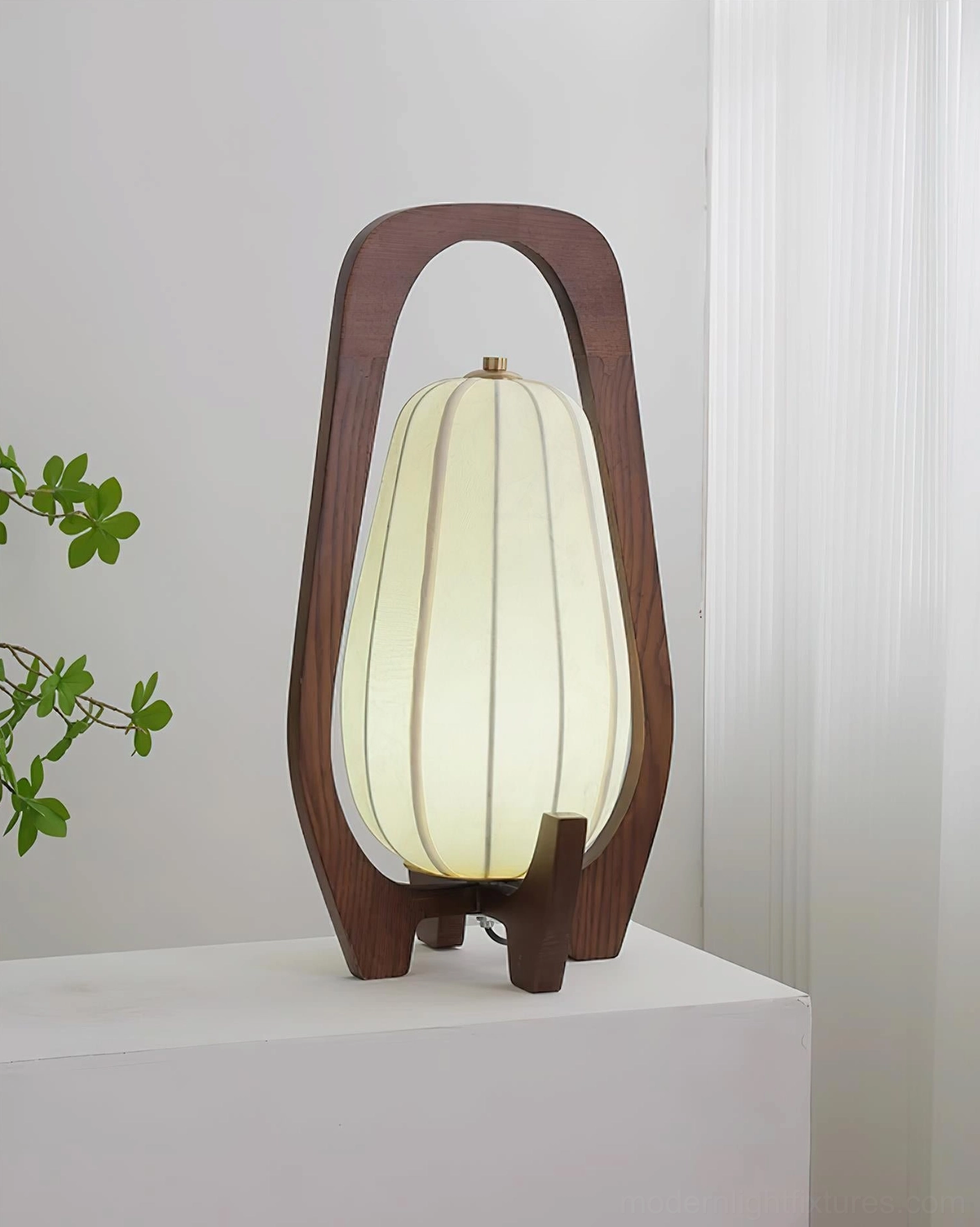 Walnut wooden table lamp with segmented fabric shade, contemporary Scandinavian design product detail photography