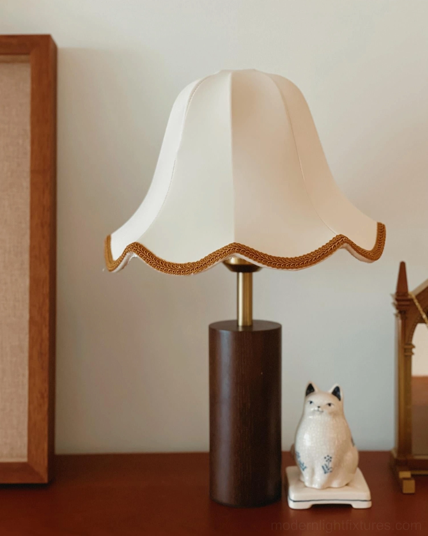 Wooden base construction of walnut table lamp showing hand-finished wood craftsmanship and brass stem