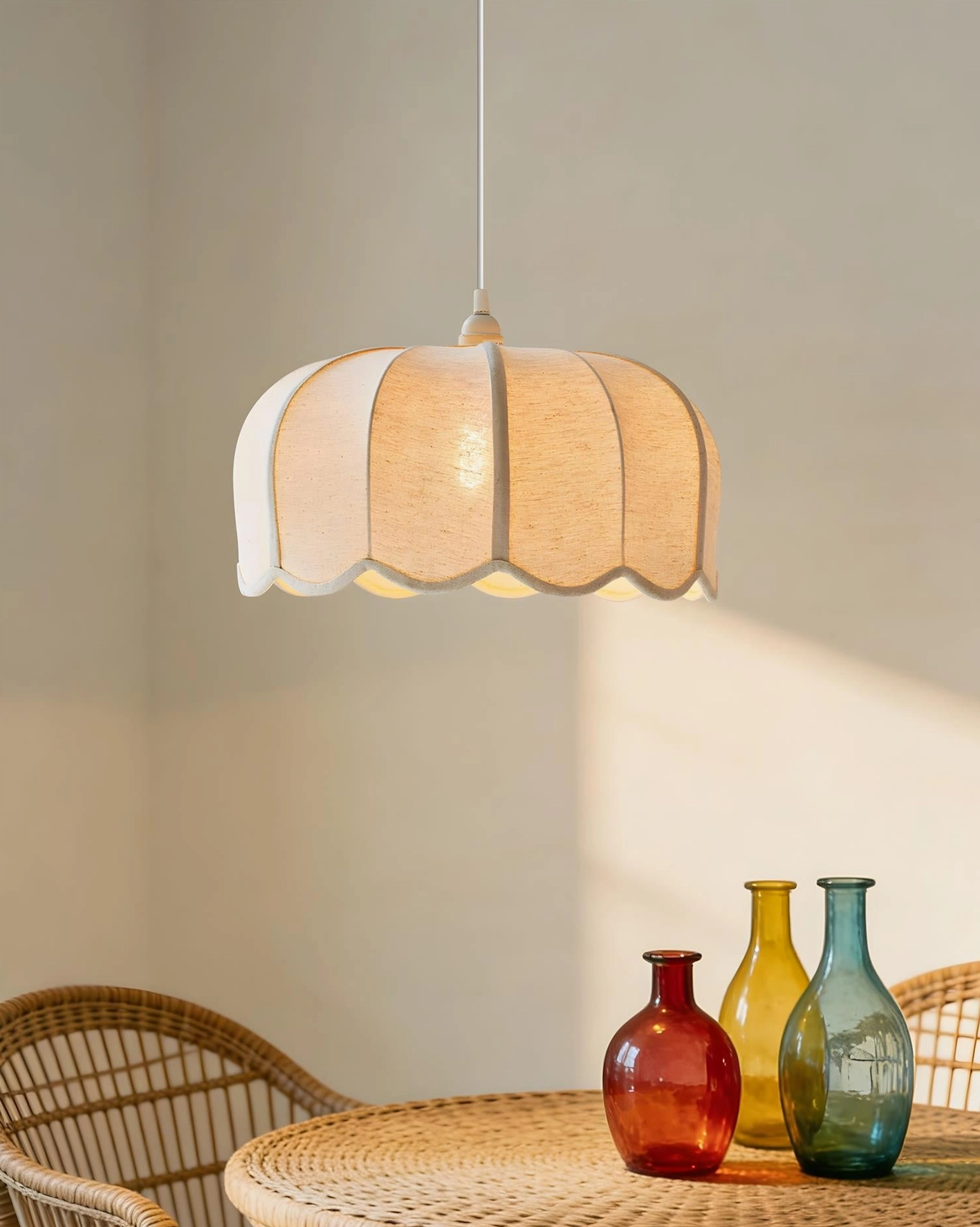 Warm glow pendant light creating intimate ambiance with scalloped fabric shade design