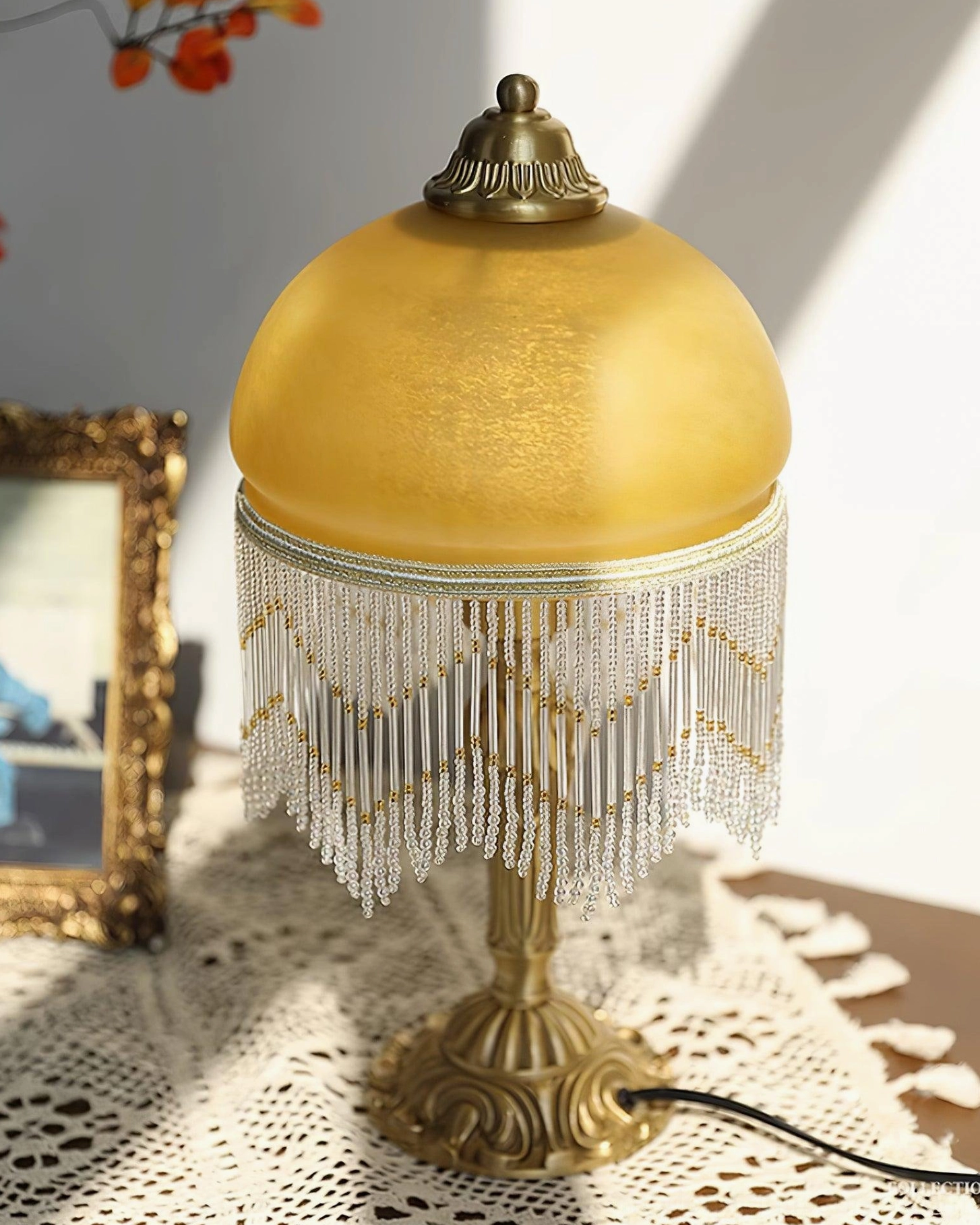 Warm glowing vintage brass tassel table lamp creating ambient lighting for cozy interior spaces