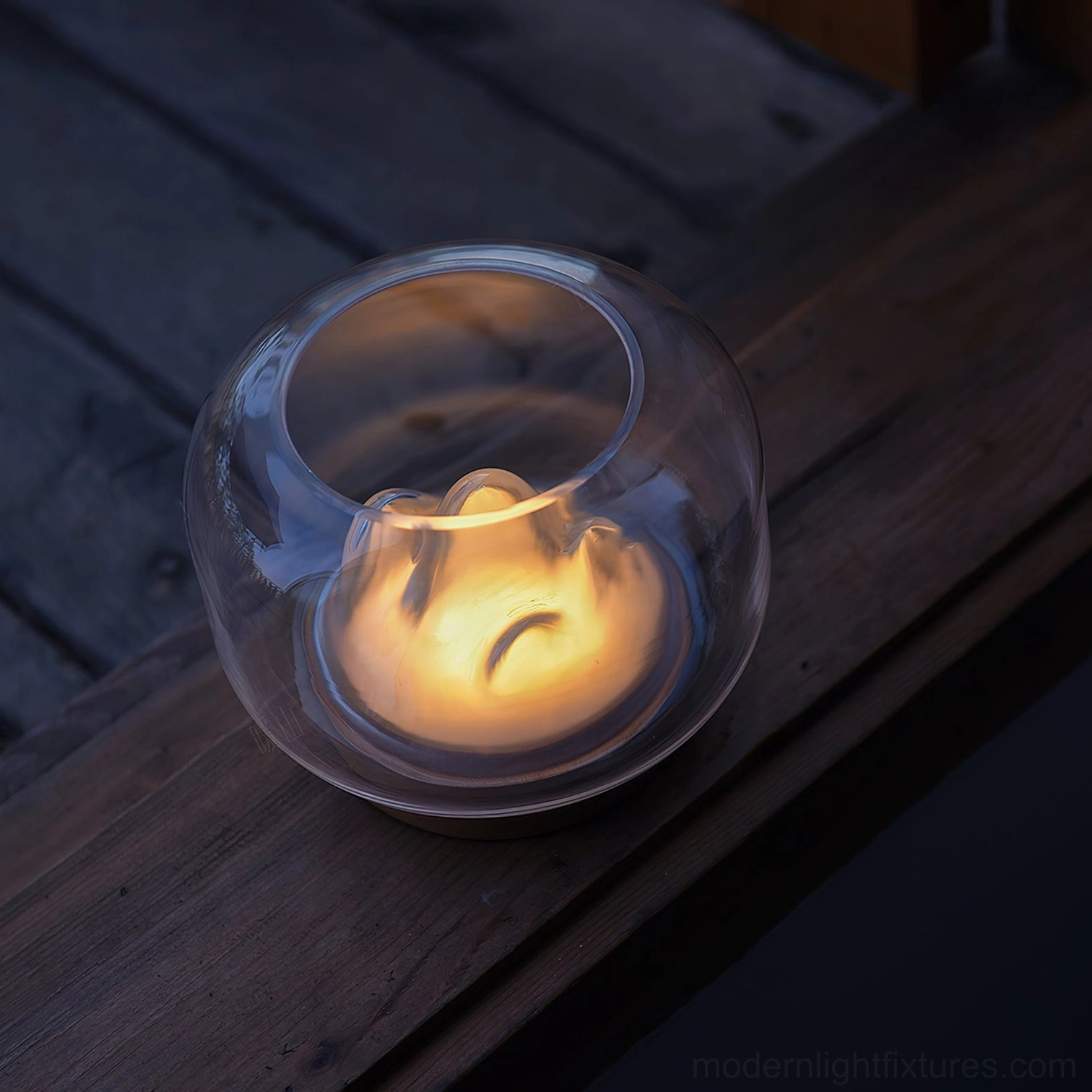 Warm mountain ambient lamp overhead angle on wooden plank surface, transparent glass shell with glowing peak
