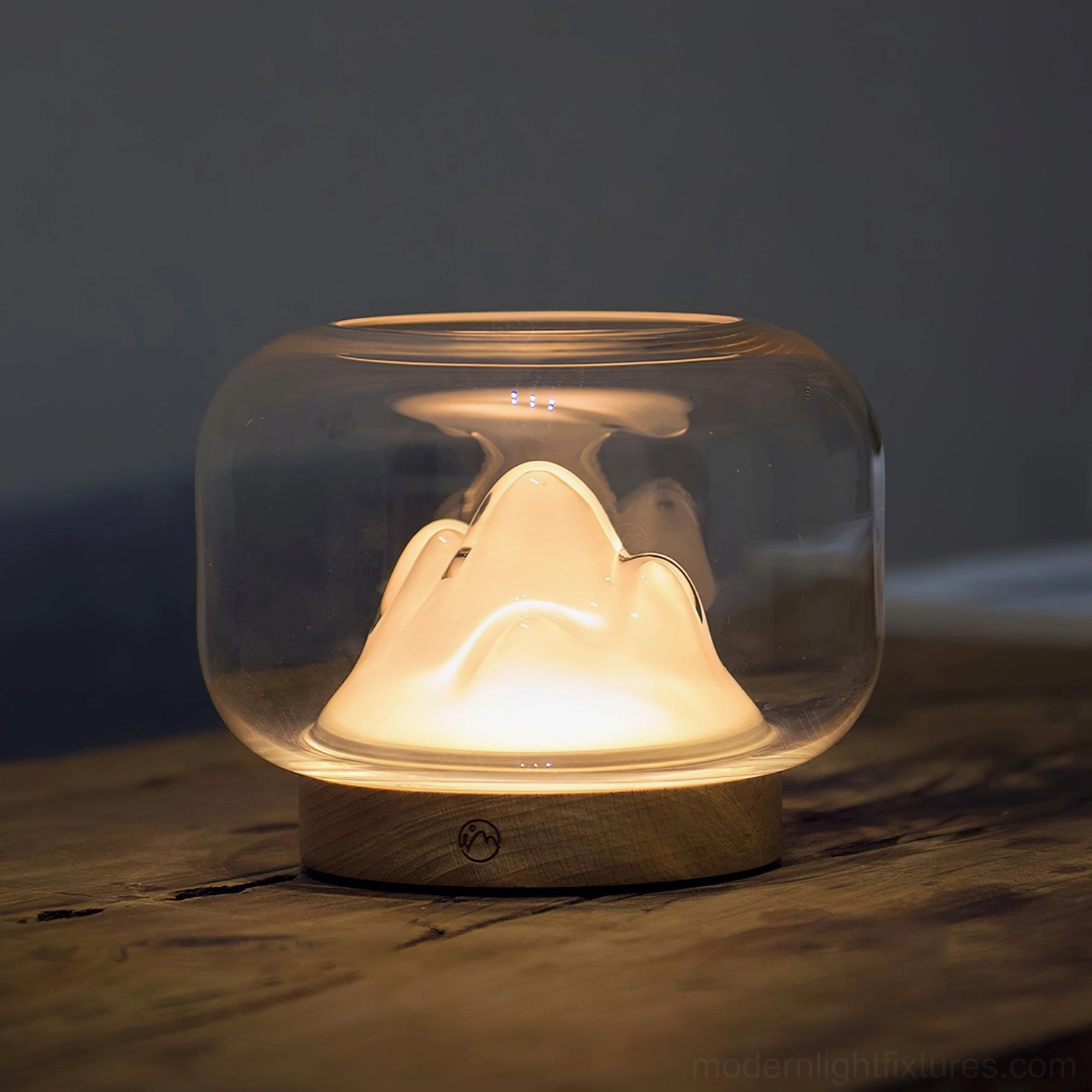 Warm mountain glass table lamp lifestyle image, contemporary minimalist home decor setting, ambient warm white lighting