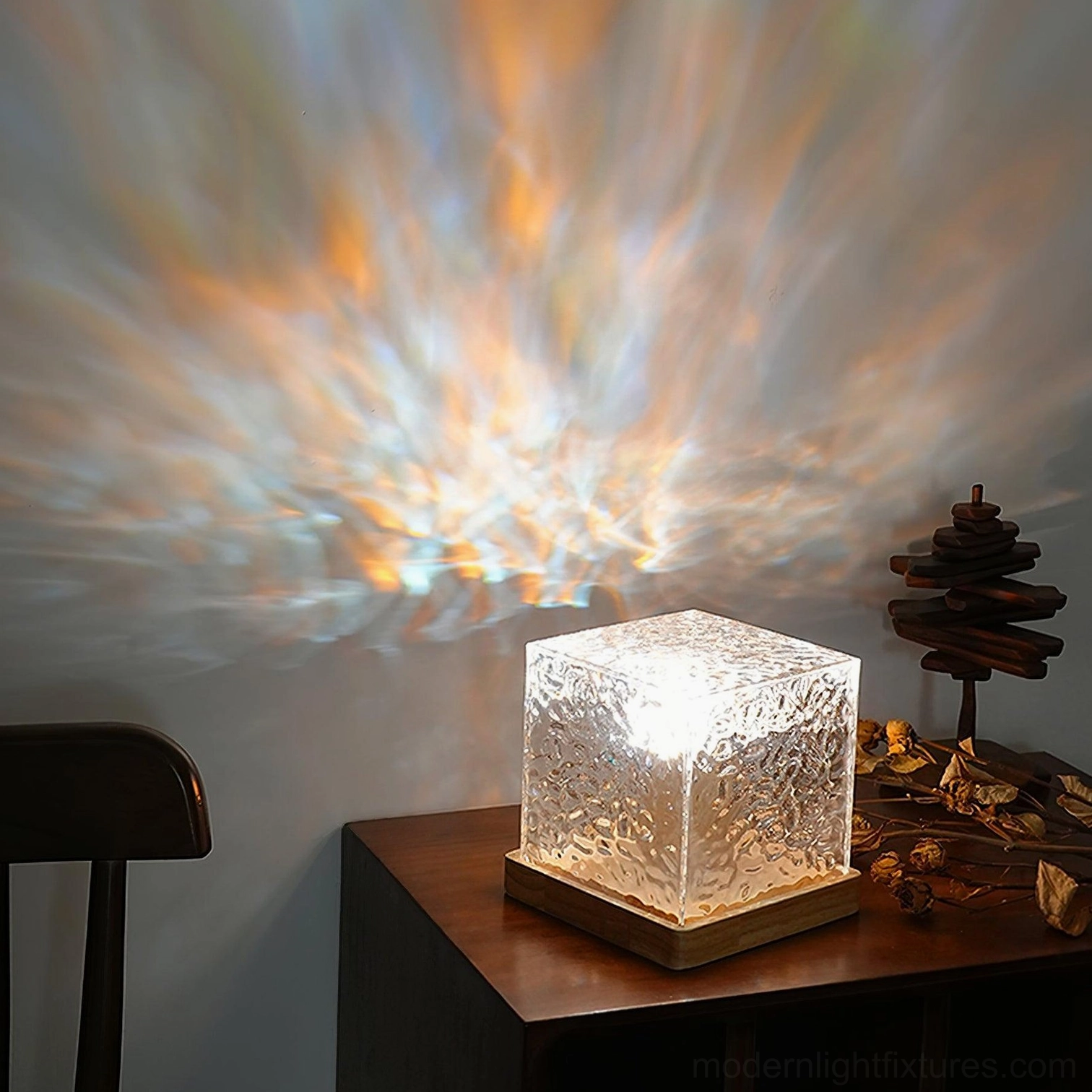 Cool white-blue LED water ripple table lamp on home side table with clear glass shade casting cool light ripple pattern