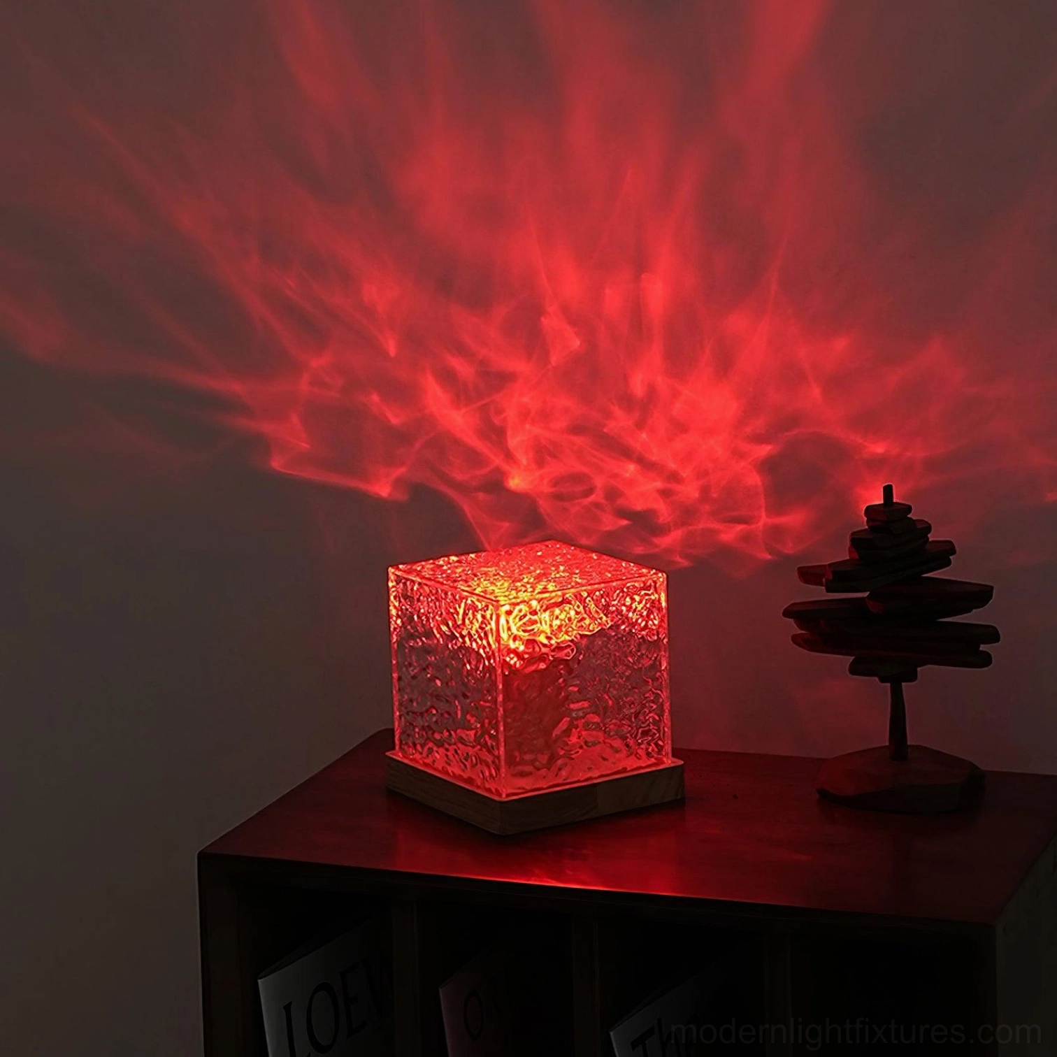 Red LED water ripple table lamp on dark home shelf with minimalist decor, casting deep red ripple light projection