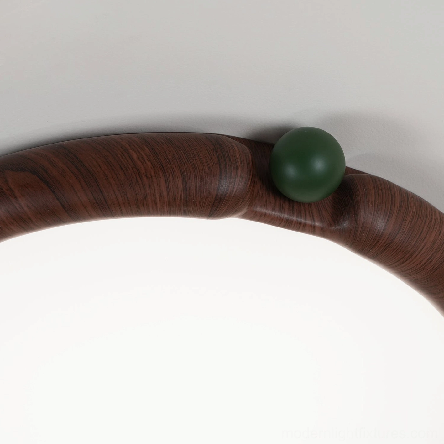 Round ceiling light fixture with water-transfer wood-grain finish, studio product image