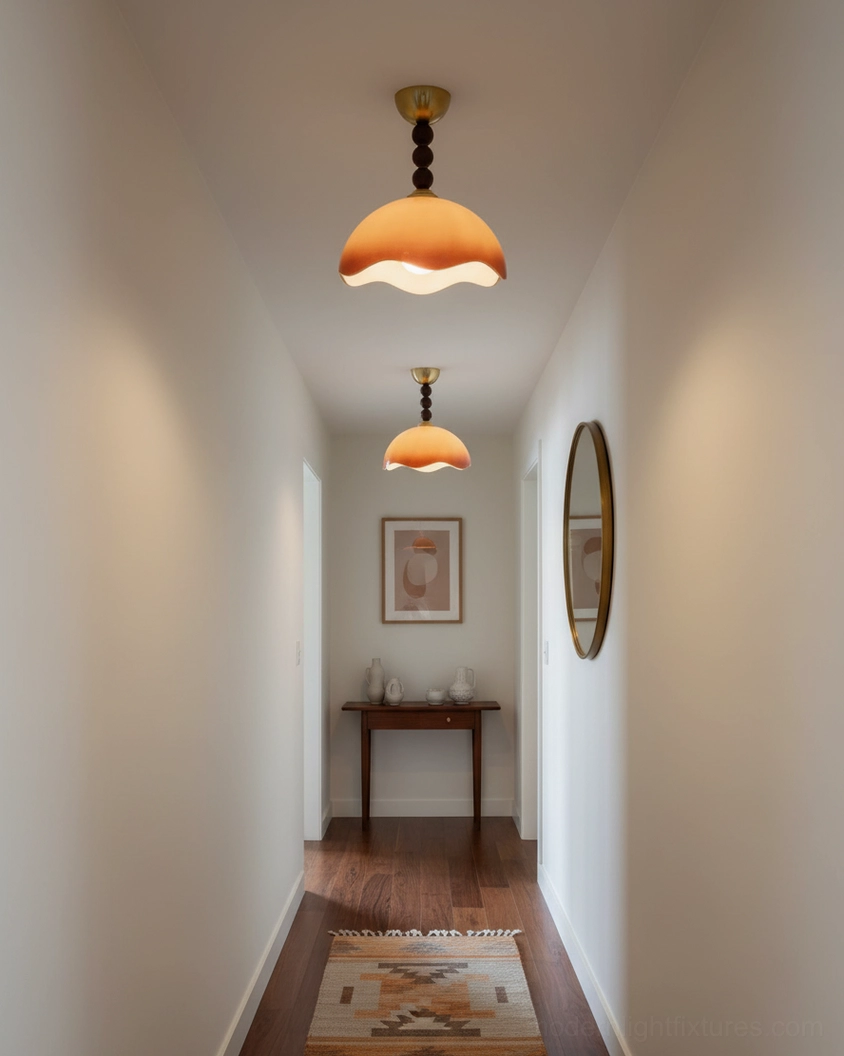 Pair of matching Wave Coralia gradient brown wavy ceiling lights illuminating minimalist hallway corridor