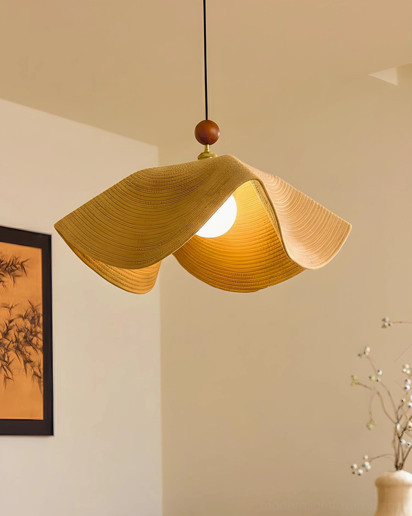 Natural rattan wave pendant light with brass accents and wooden sphere canopy closeup