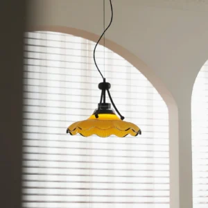 Wavelet amber ribbed pendant lamp hanging in cozy interior space with arched louvered windows, vintage modern lighting