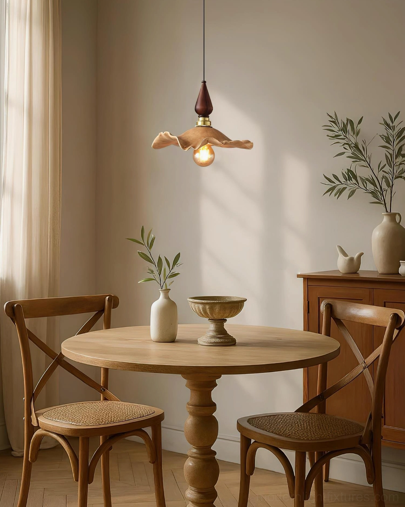 Wavely sculptural pendant lamp illuminated over dining area with vintage wooden furniture and neutral decor