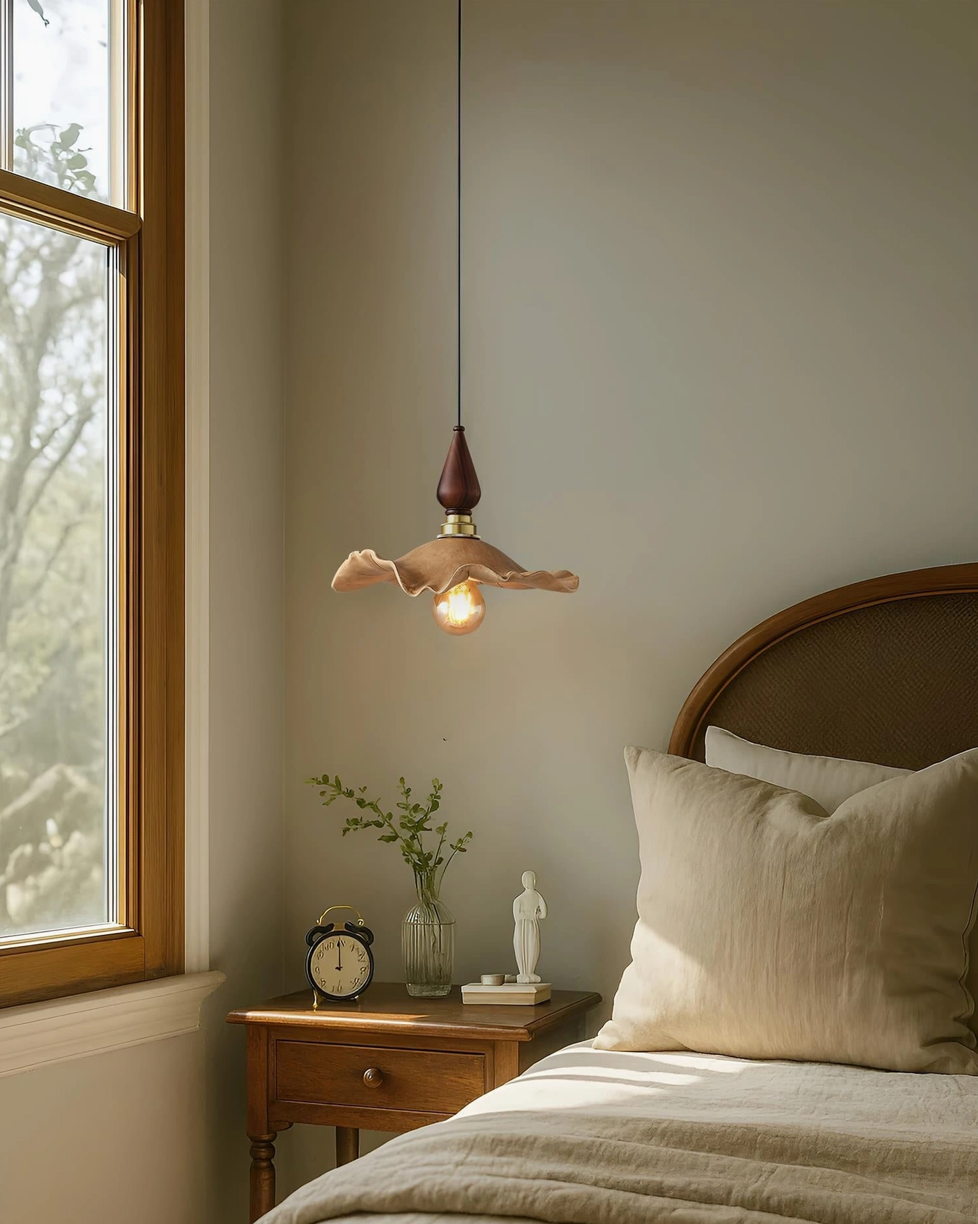 Wavely organic pendant light installed in cozy rustic bedroom beside wooden bed and nightstand