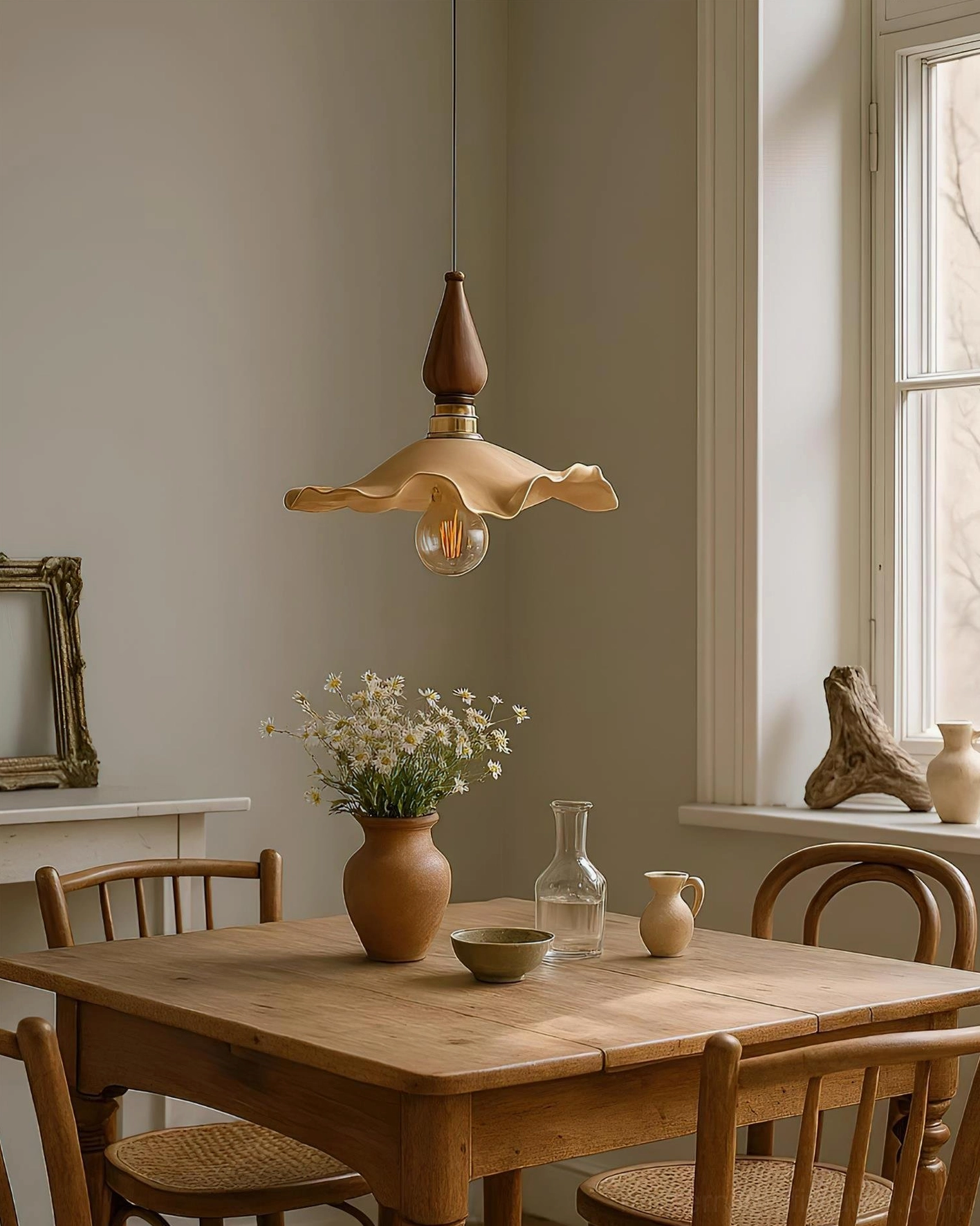 Wavely pendant light installed above wooden dining table in rustic farmhouse dining room setting