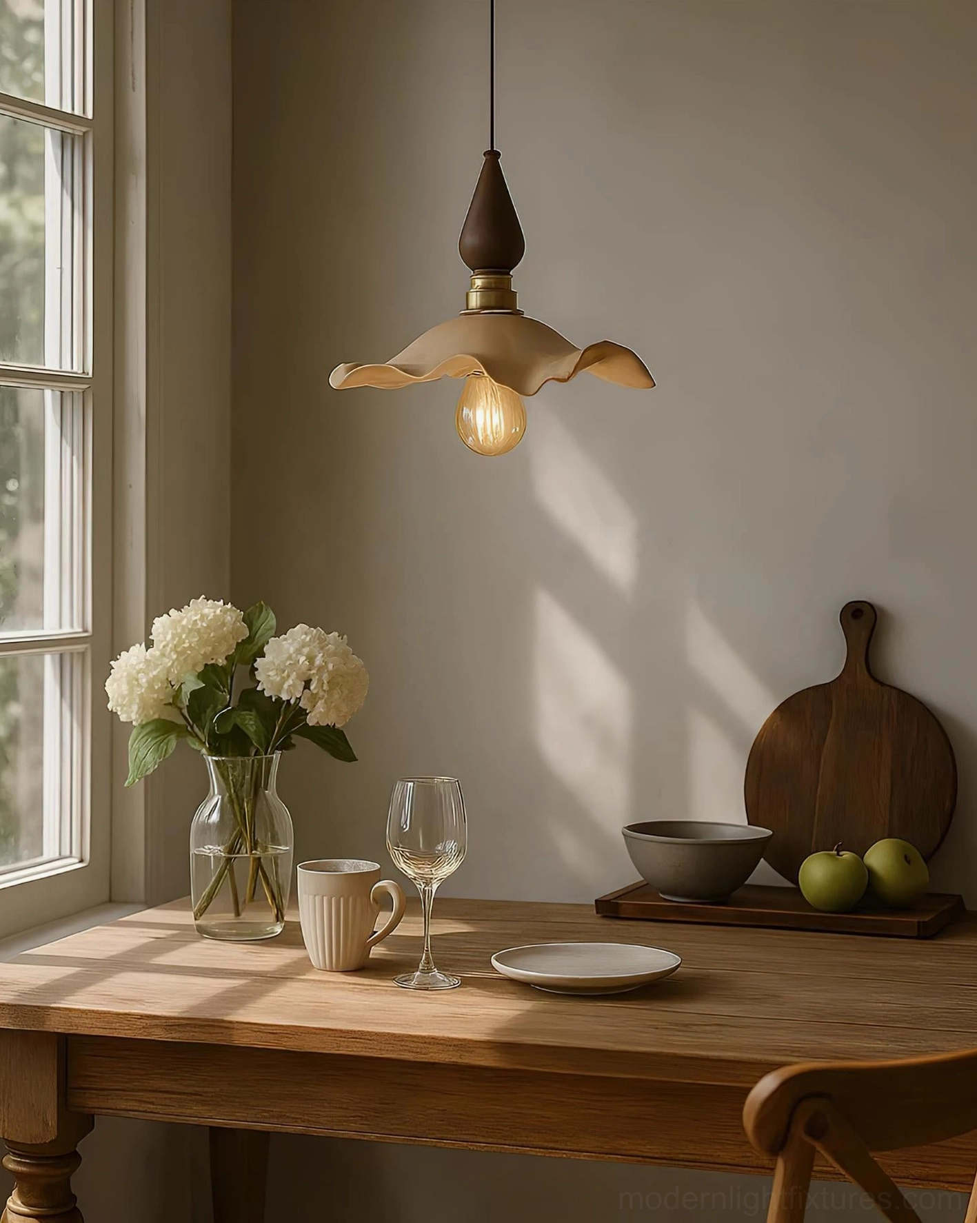 Wavely resin pendant light hanging in farmhouse dining room with floral table arrangement and warm ambient glow