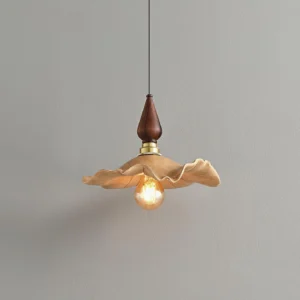 Wavely organic pendant light featuring rippled resin shade with brass hardware and warm wood finial, three-quarter angle