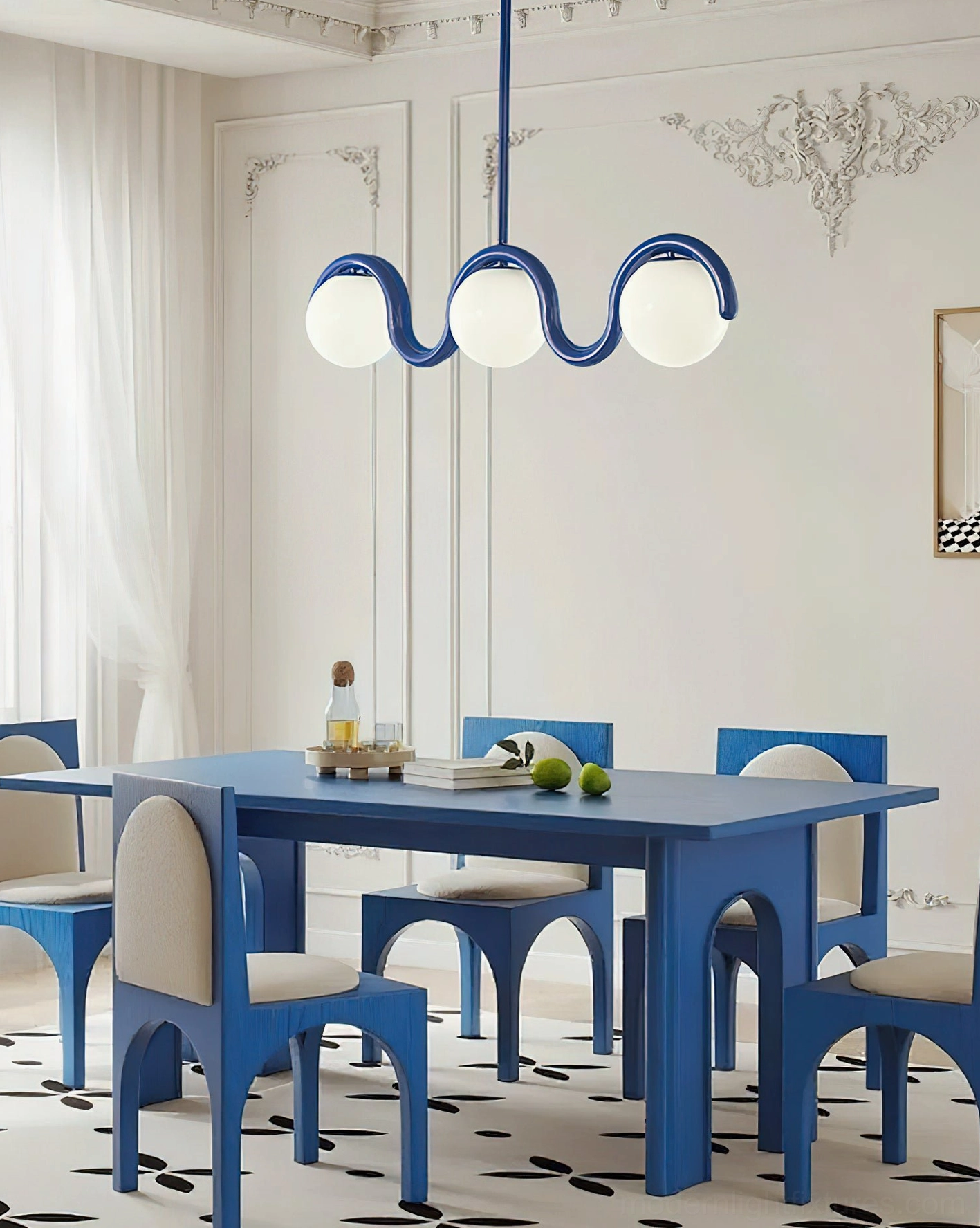 Modern dining room with 3-light blue wave chandelier installed above dining furniture in contemporary interior