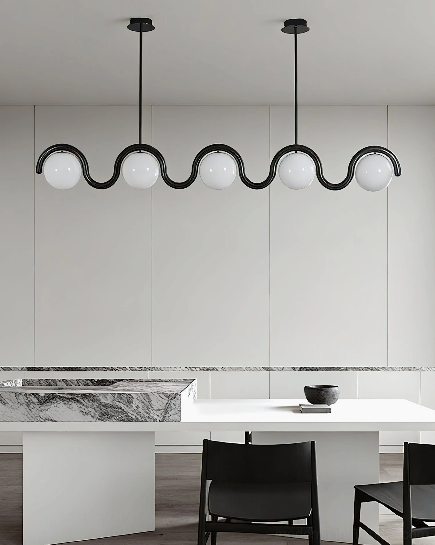 5-light wavy linear chandelier with black metal frame and frosted white globe shades in modern kitchen