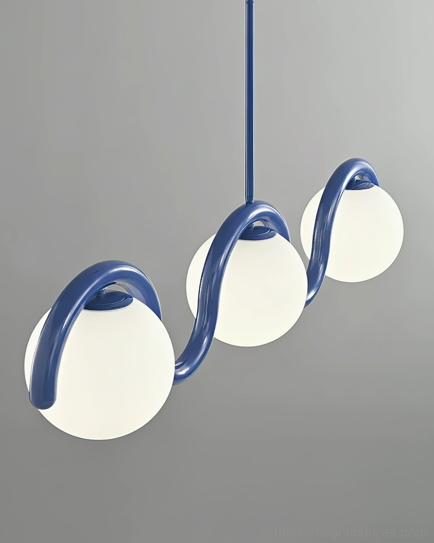 Close-up side view of blue wavy chandelier showing curved metal arms and matte frosted lamp shades