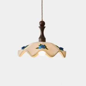Wavy scalloped fabric pendant light with blue floral appliques, front close-up view showcasing hand-applied details and fabric texture