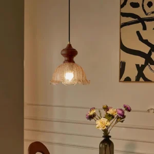 Vintage pendant light installed in entryway with warm ambient lighting and decorative wall art setup
