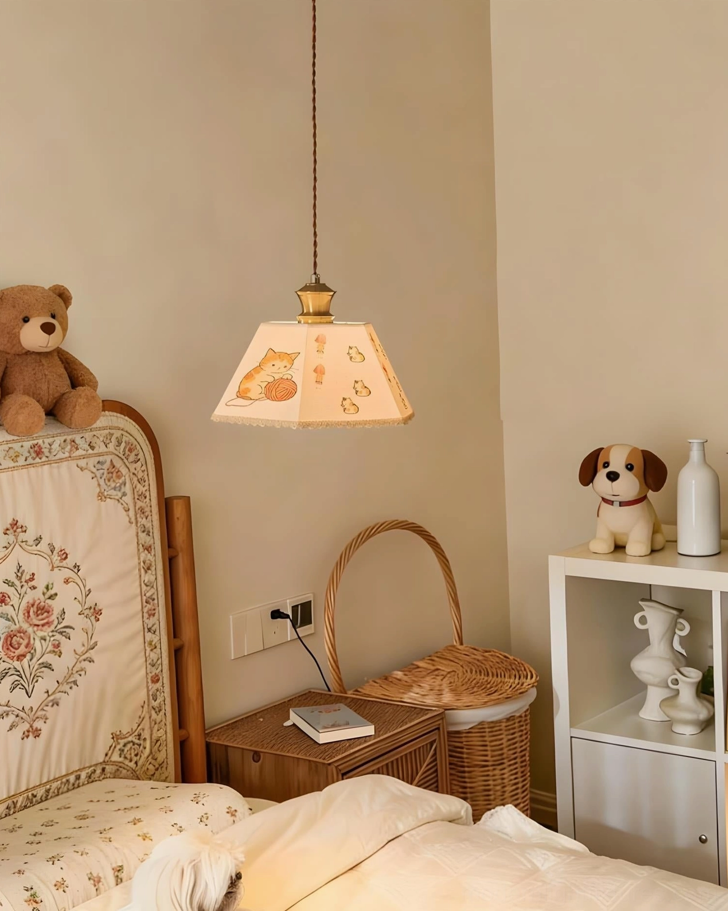 Contemporary fabric pendant light with illustrated cat and yarn print, warm wall background