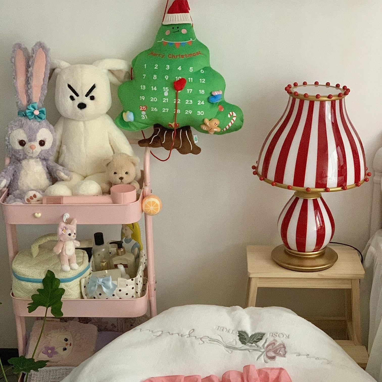 Whimsical table lamp with red and white striped pattern and decorative embellishments
