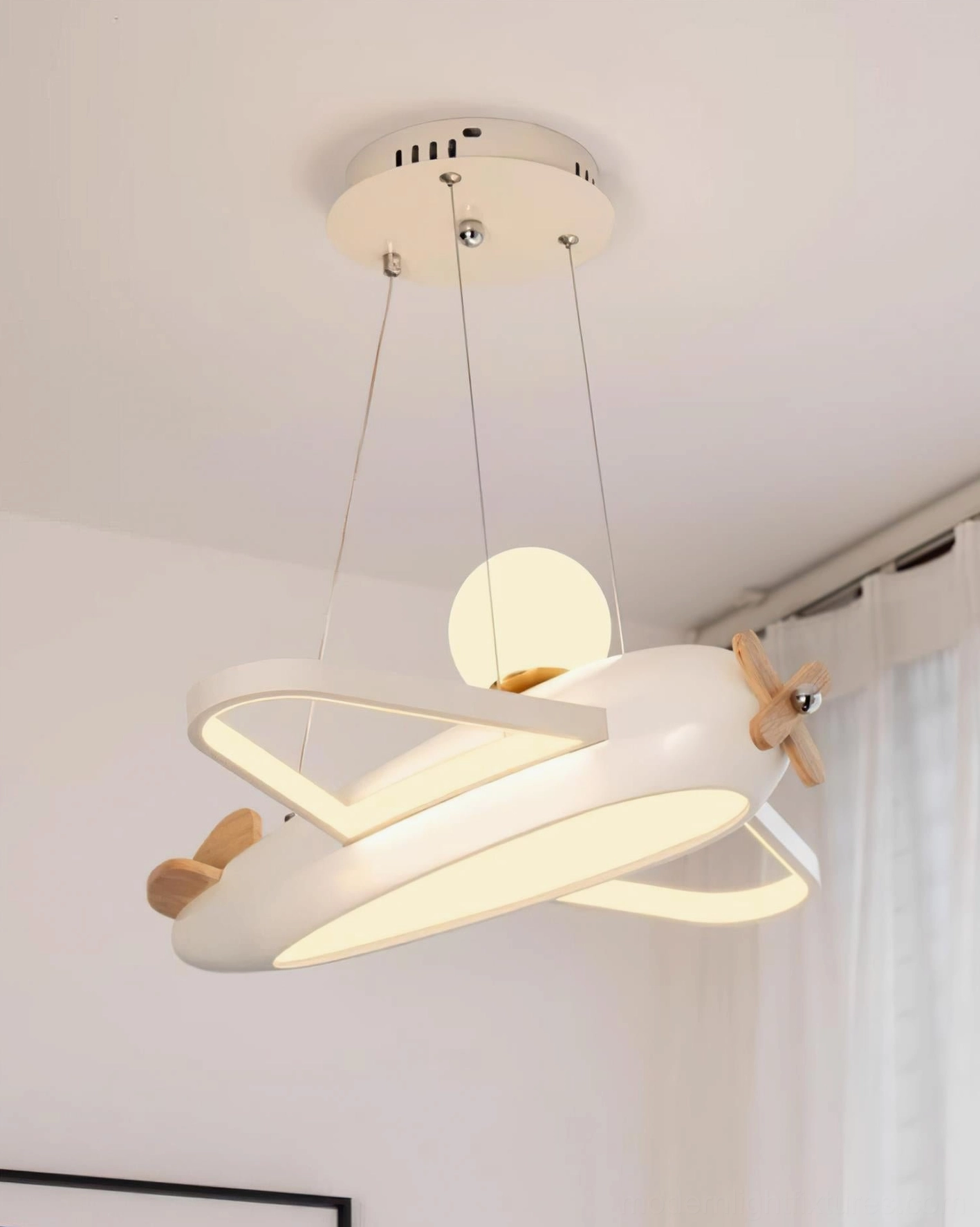 White airplane pendant light spherical warm glow creating cozy ambient illumination in nursery bedroom