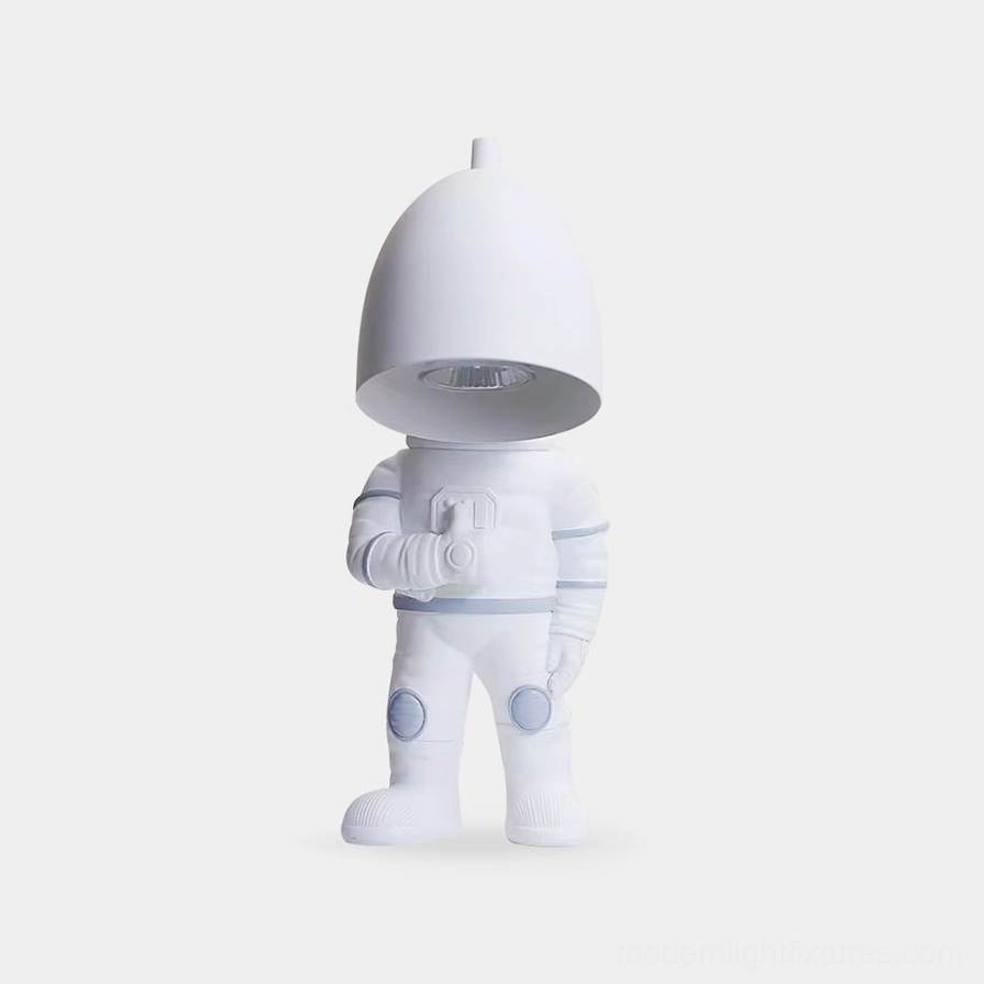 Modern white astronaut candle warmer table lamp with matte resin finish on plain background