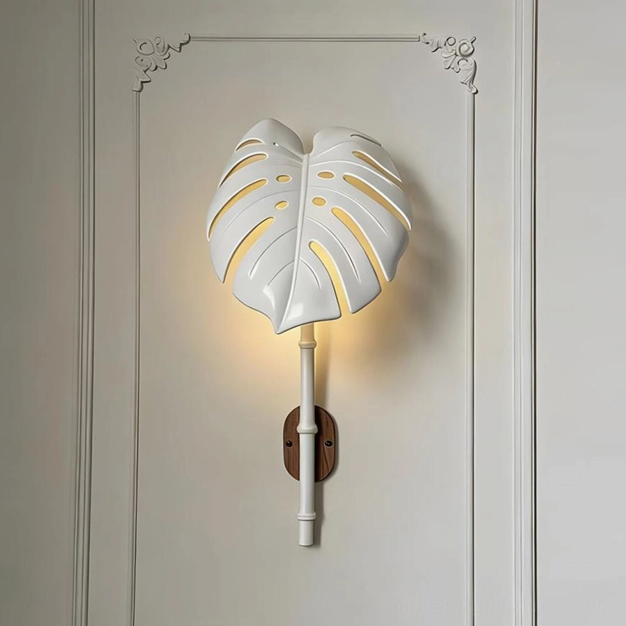 White botanical wall lamp illuminated on studio paneled wall displaying warm light glow