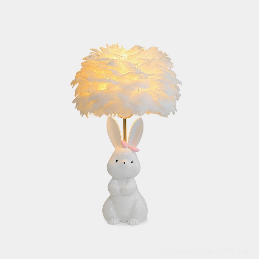 Pastel white ceramic bunny table lamp with feather shade and pink bow - frontal studio view