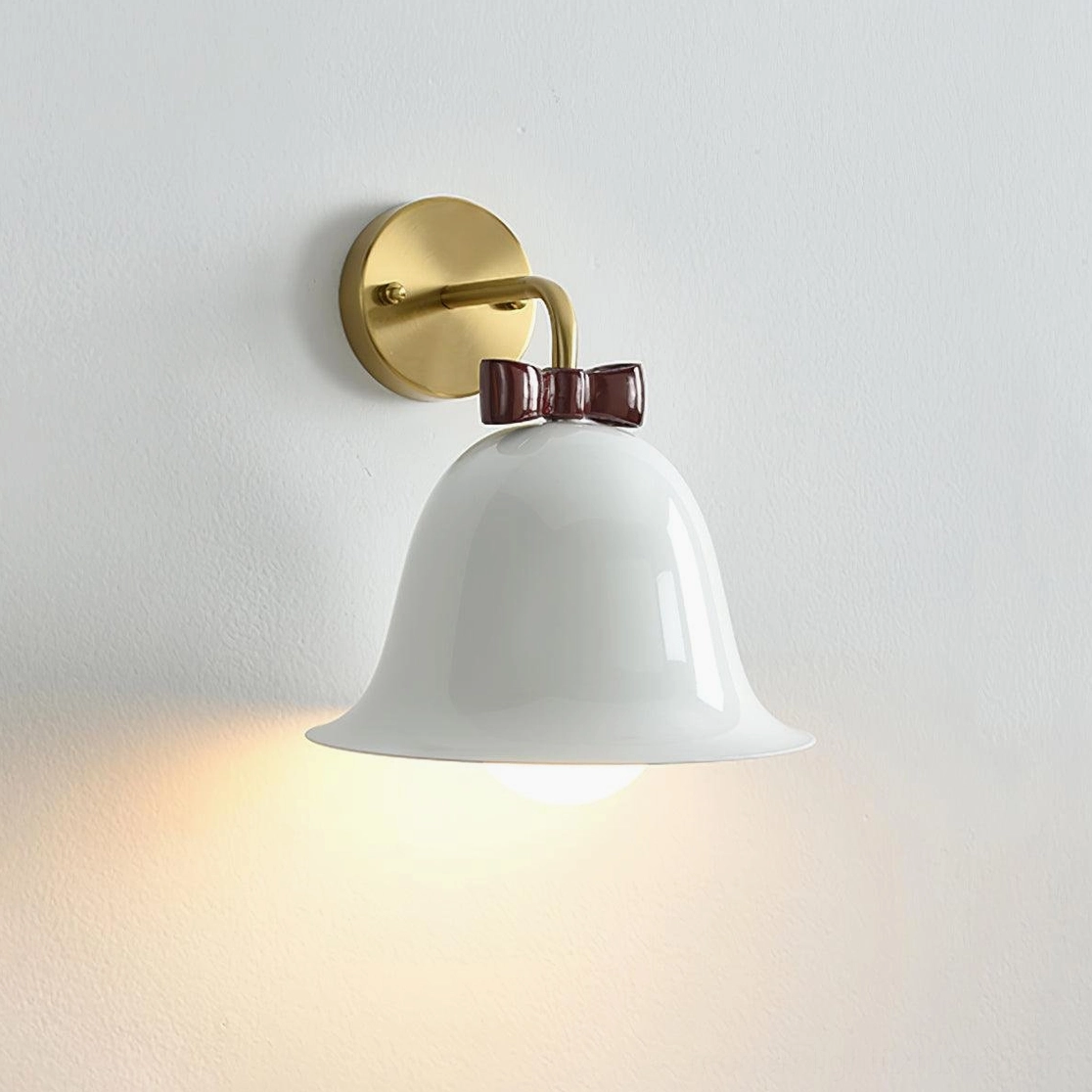 White glossy ceramic bell wall lamp with dark brown bow knot accent and simple cute Nordic aesthetic