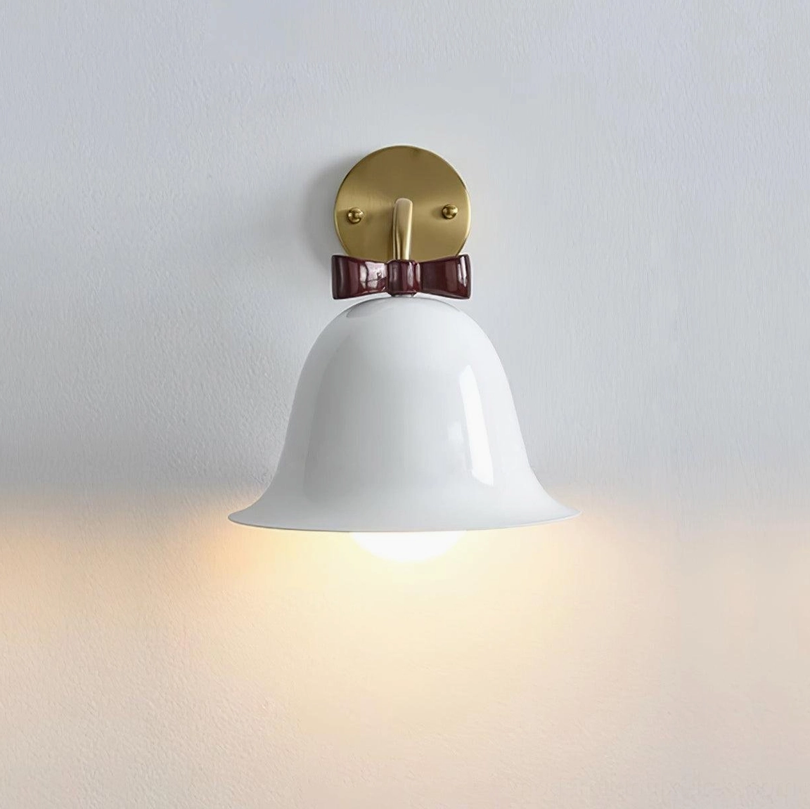 White ceramic bell wall sconce with clean contemporary lines and elegant brass mounting bracket