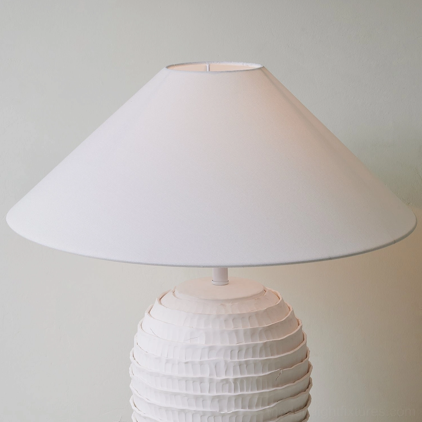 Close-up detailed view of white ribbed ceramic lamp base showing textured wave pattern and fabric shade