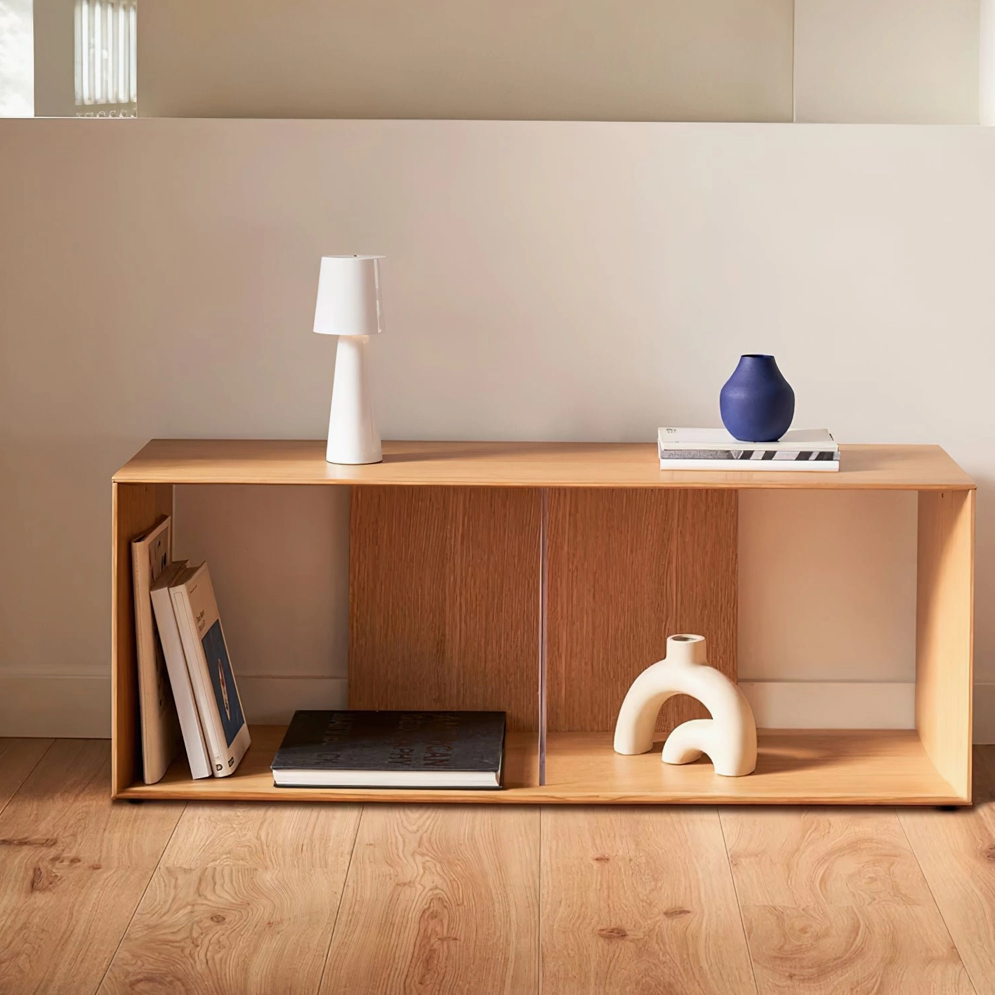 Pure white matte ceramic tapered table lamp on wooden open shelf Scandinavian decor