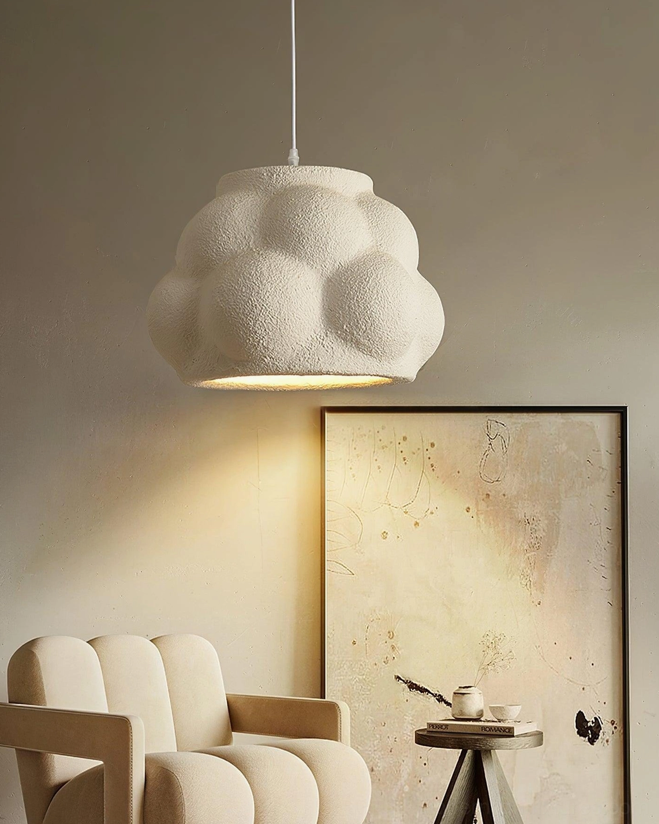 White matte wabi-sabi cloud pendant lamp side view in cozy lounge corner with warm downlighting