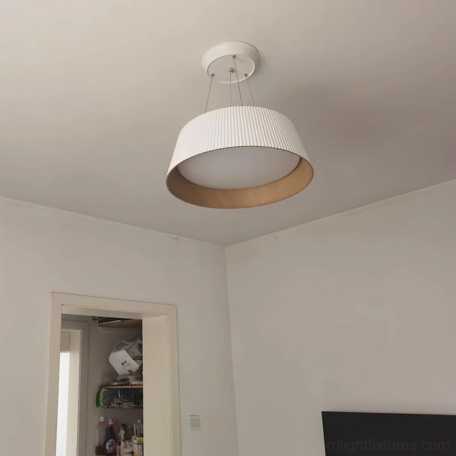 White Delta pleated pendant lamp in home entryway and kitchen area with wood interior illumination