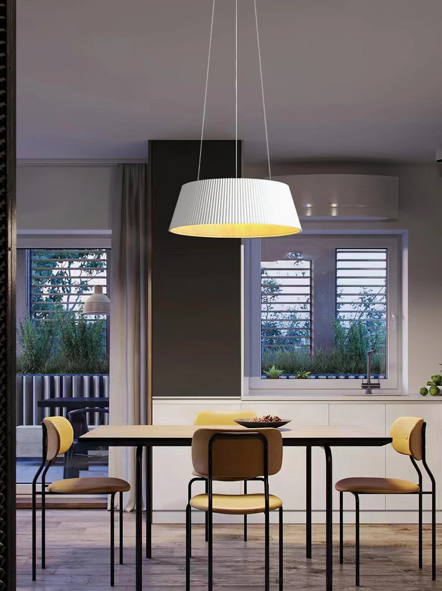 White Delta drum pendant light above round dining table with yellow accent chairs, modern dining