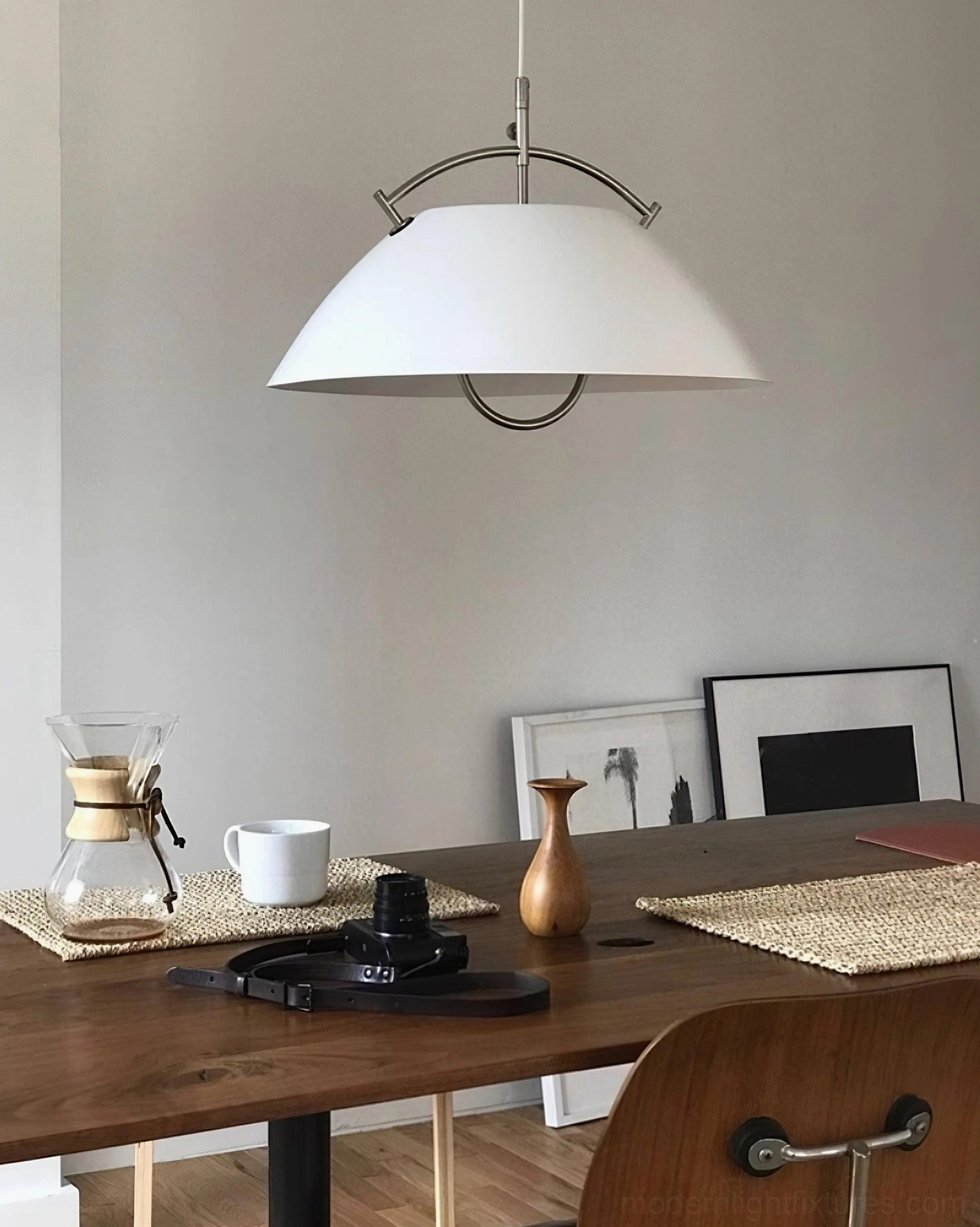 White dome pendant light in contemporary home dining room setting with table decor