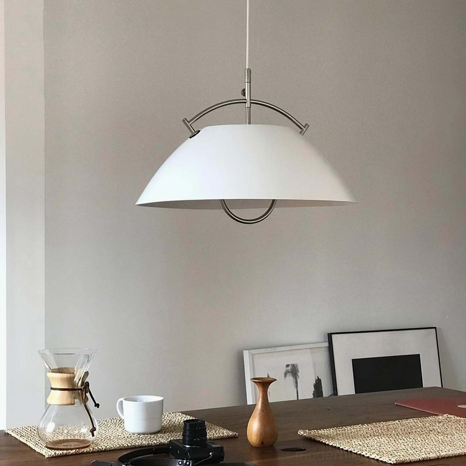 White modern dome pendant light with polished silver hardware in contemporary dining space