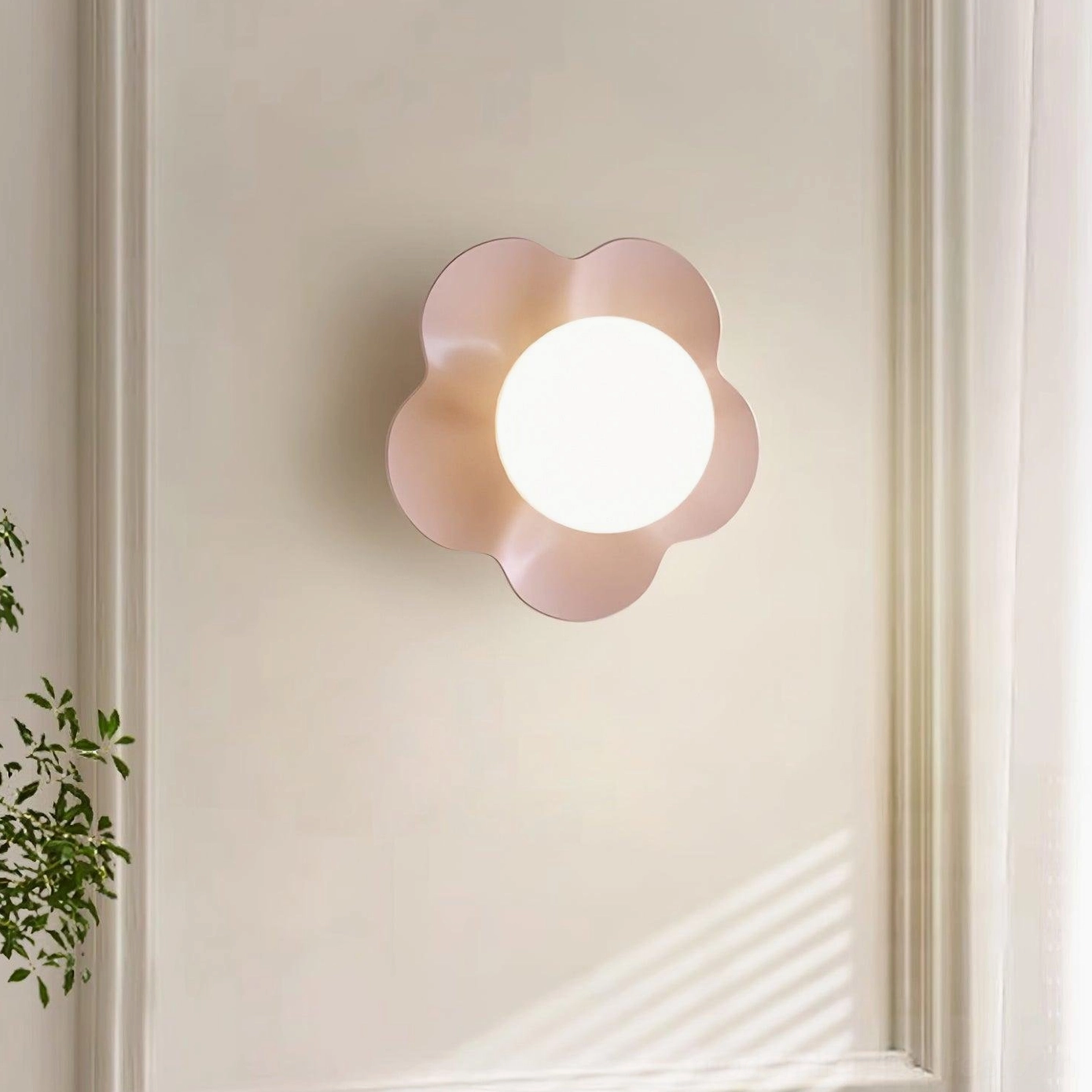 White Fleur wall lamp illuminated beside bedroom window - minimalist modern wall sconce with dimensional petal design