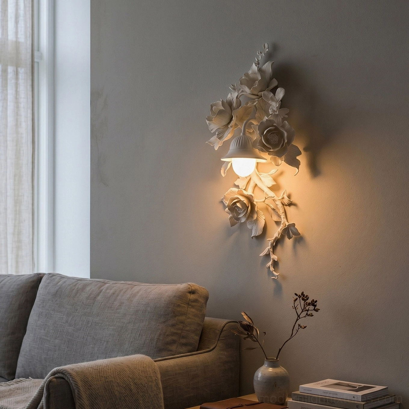 Off-white Elysia Bloom wall sconce in contemporary living room with gray sofa, warm accent lighting on botanical relief
