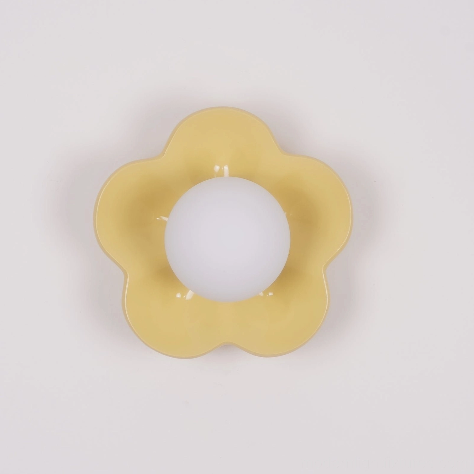 White flower wall lamp mounted in bright minimalist interior space with natural light