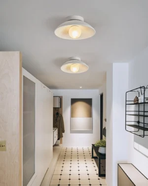 Nubei ceiling light fixture installed in modern white minimalist residential hallway, overhead perspective showing sleek integration
