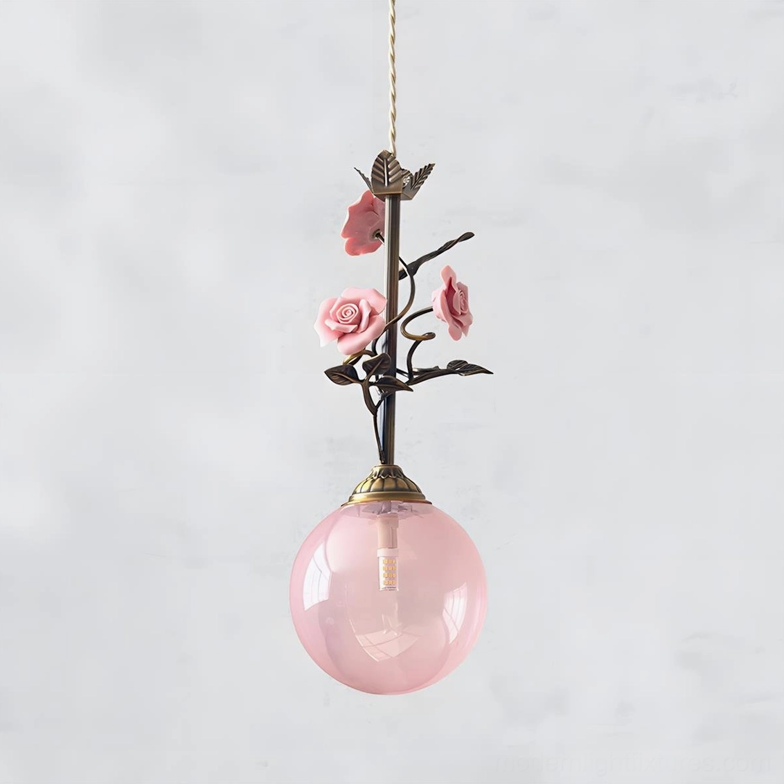 White frosted floral pendant lamp with brass rose details, warm ambient lighting