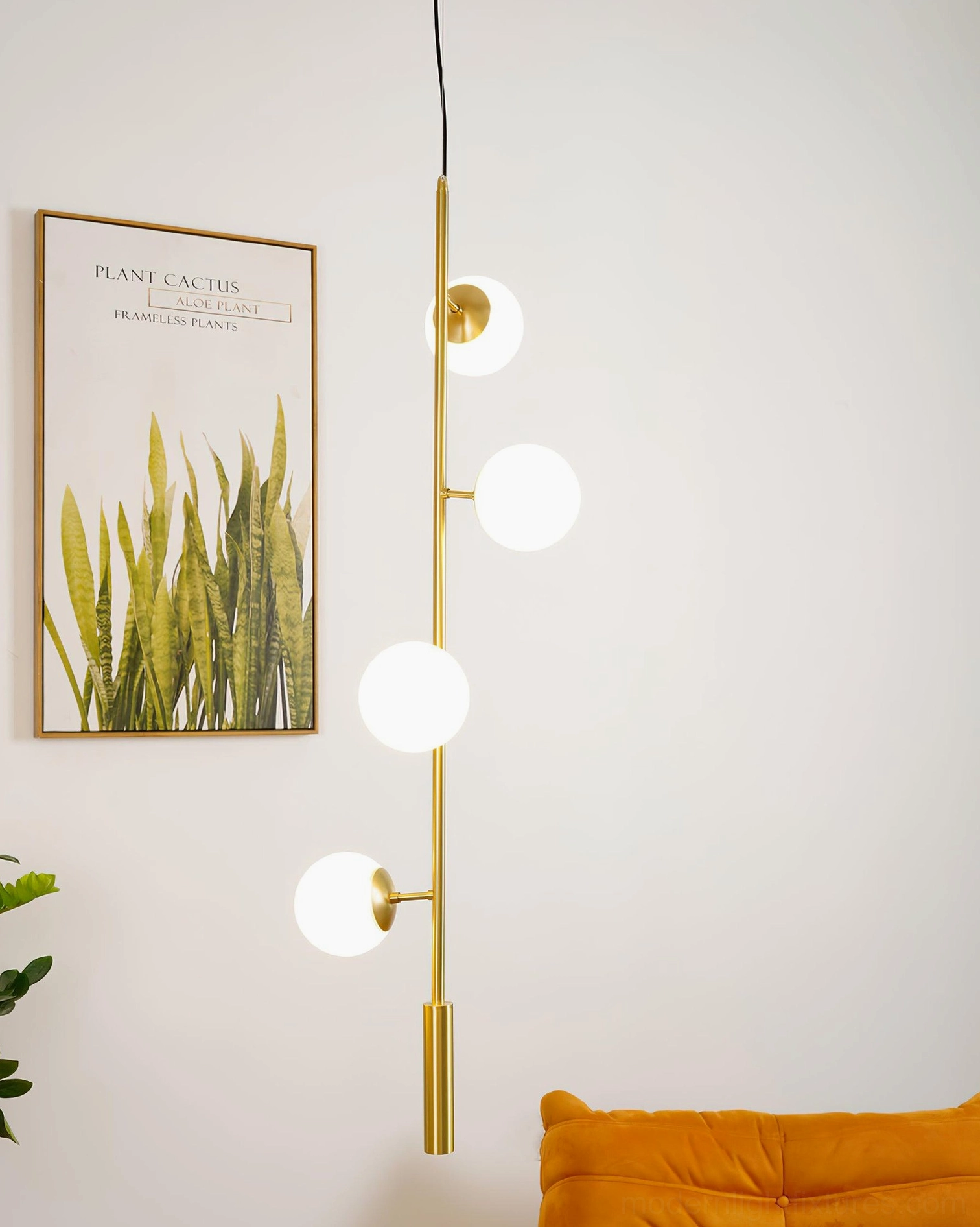 Frosted white glass orb chandelier with brass frame on minimalist accent wall