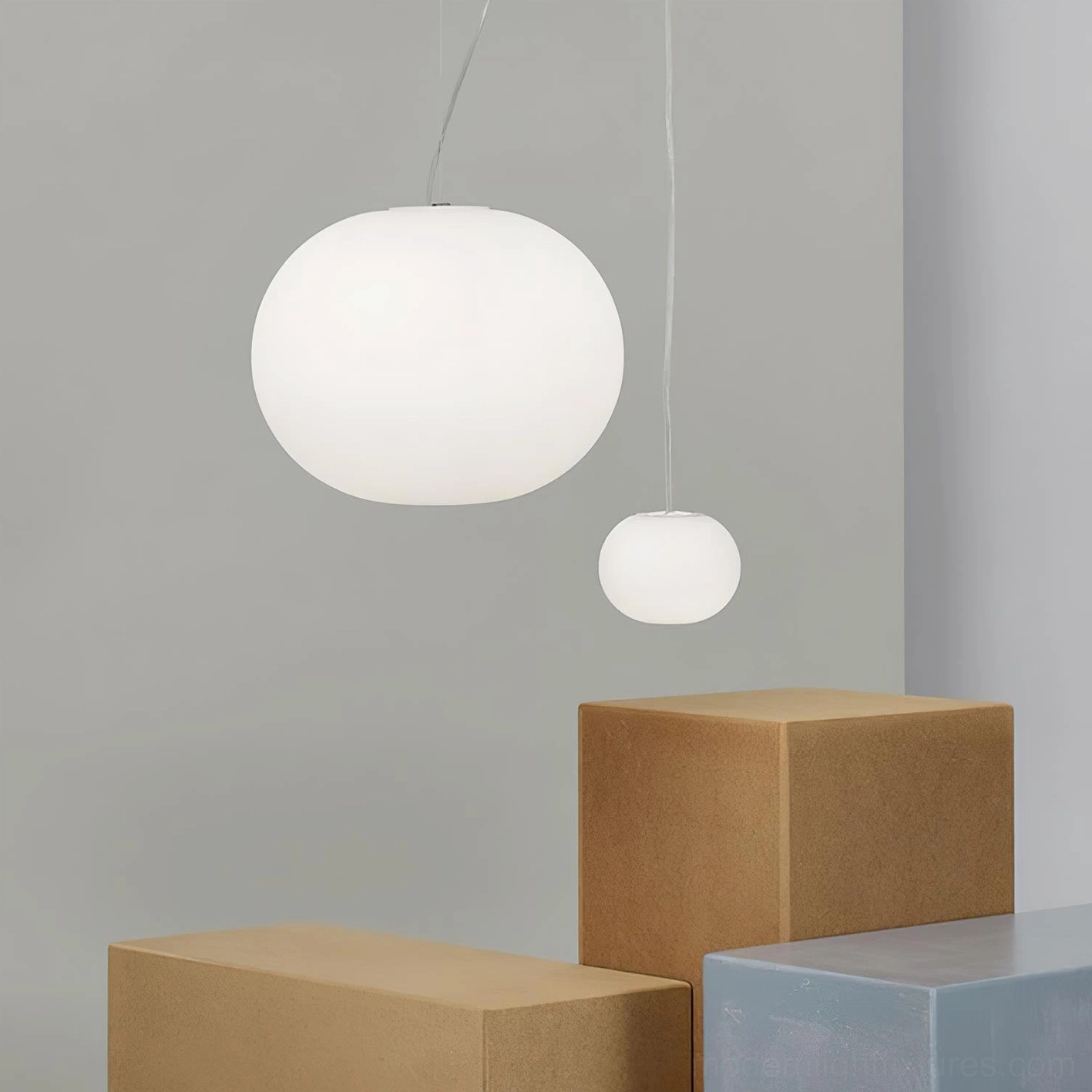 Two frosted glass sphere pendants in minimalist display space with geometric blocks - white pendant lamps modern design showcase