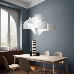 Modern white geometric pendant lamp hanging in contemporary residential dining room with blue-gray walls