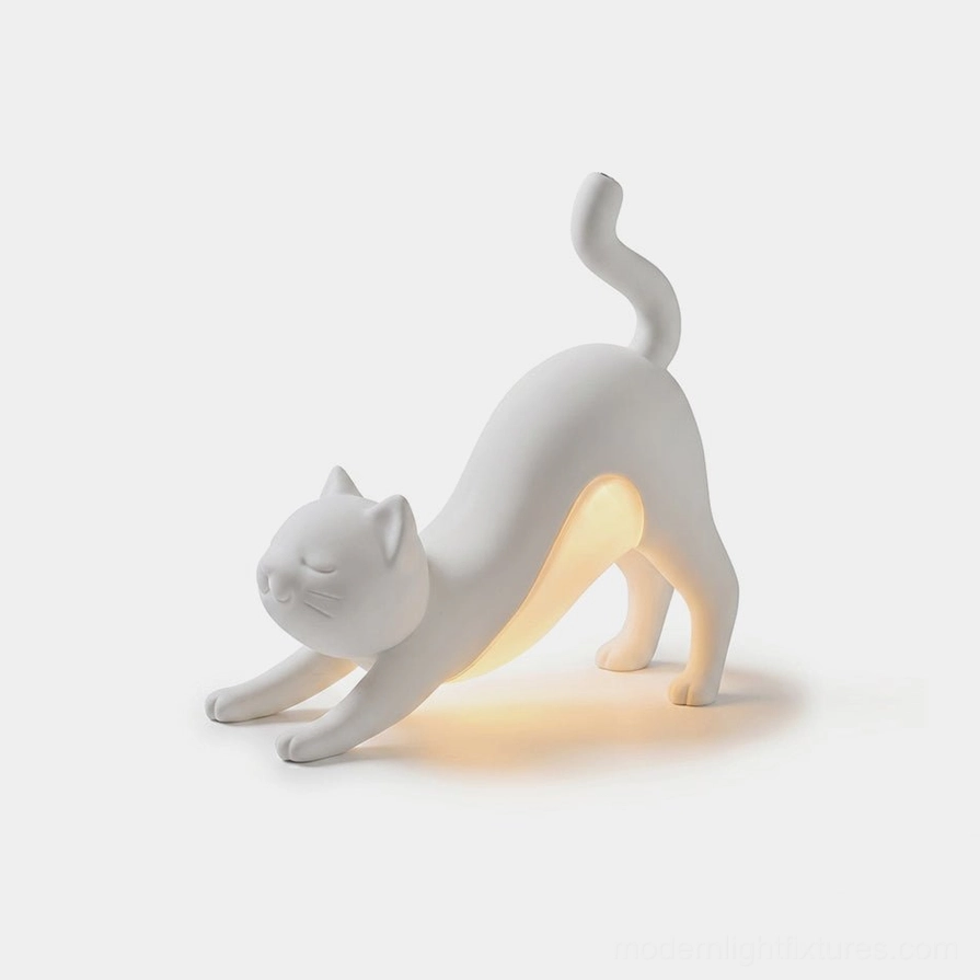 White Hakimi stretching cat table lamp with sculptural form and integrated LED light
